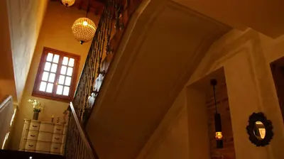 a staircase in a building with a window and a chandelier at La Mozaira in Alboraya