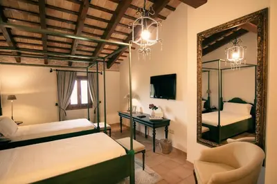 a bedroom with two beds and a mirror at La Mozaira in Alboraya