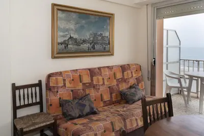 a living room with a couch and a table with chairs at Apolo, 5º- 30 in Cullera