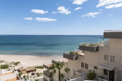 a view of the beach from the balcony of a building at Dosel, 6º-30 in Cullera
