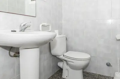 a bathroom with a white toilet and a sink at Estirpe, 2º-4 in Cullera
