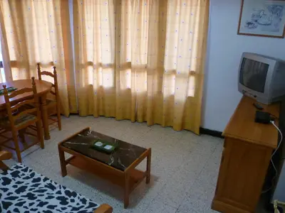 a living room with a tv and a coffee table at Estirpe, 3º-5 in Cullera