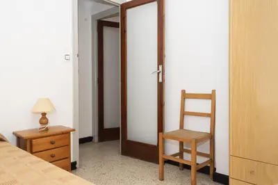 a bedroom with a door and a chair and a mirror at Estirpe, 3º-6 in Cullera