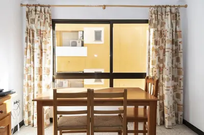a dining room with a table and chairs and a window at Estirpe, 3º-6 in Cullera