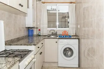 a kitchen with a washing machine and a sink at Estirpe, 4º-8 in Cullera