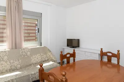 a living room with a table and a couch at Estrella, 6º-36 in Cullera