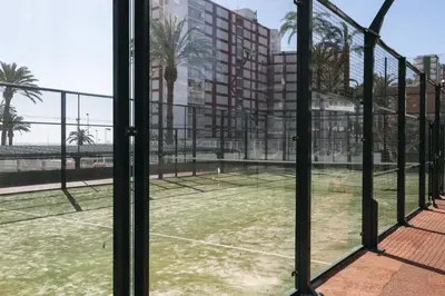 a tennis court seen through a window at Florazar 1, I-A 7-B in Cullera