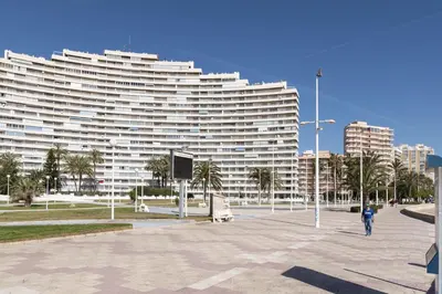a large white building with palm trees in front of it at Florazar 1, I-A 7-B in Cullera