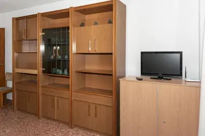 a wooden entertainment center with a television in a room at Florazar 2, Ii-14-A in Cullera