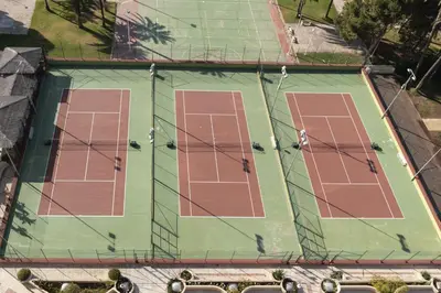 an overhead view of a tennis court with red lanes at Florazar 2, Iv-14-C in Cullera