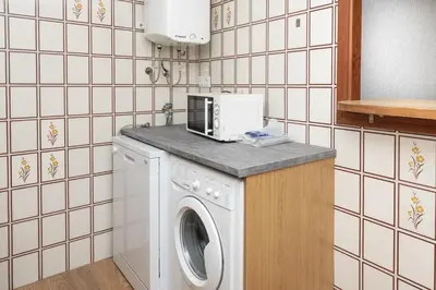 a kitchen with a washing machine and a microwave at Florazar 2, Ix-7-B in Cullera