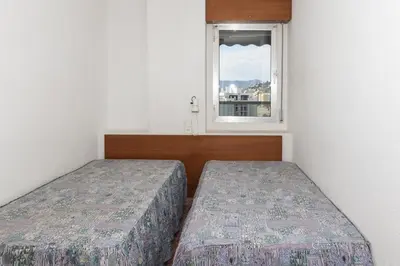 two beds in a small room with a window at Florazar 2, Vi-10-B in Faro de Cullera