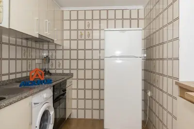 a kitchen with a refrigerator and a washing machine at Florazar 2, Vi-11-C in Faro de Cullera