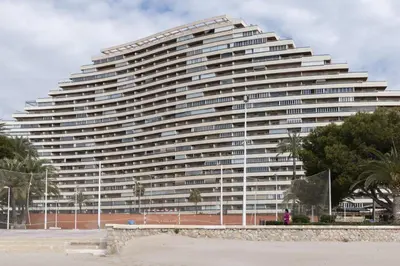 a large white building with trees in front of it at Florazar 2, Vi-11-C in Faro de Cullera