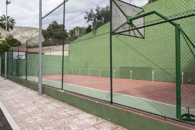 a tennis court with a fence on a tennis court at Florazar 2, Vi-11-C in Faro de Cullera
