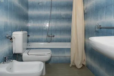 a blue tiled bathroom with a toilet and a sink at Florazar 2, Vi-13-C in Faro de Cullera