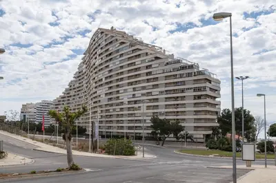 a large white building with a tree in front of it at Florazar 2, Vi-13-C in Faro de Cullera