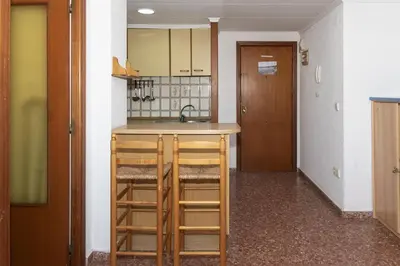 a kitchen with two stools and a counter top at Florazar 2, Vi-5-B in Cullera