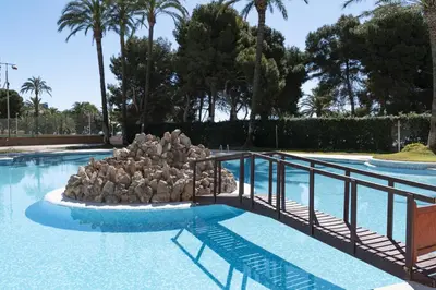 a swimming pool with a pile of rocks in it at Florazar 2, Vi-5-B in Cullera