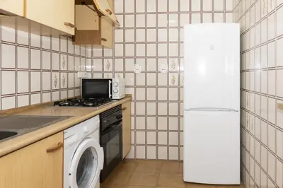 a kitchen with a refrigerator and a washing machine at Florazar 2, Vi-7-C in Cullera