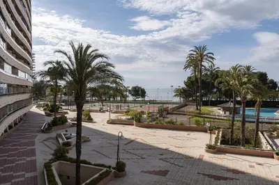 a courtyard with palm trees and a swimming pool at Florazar 2, Vii-2-A in Faro de Cullera