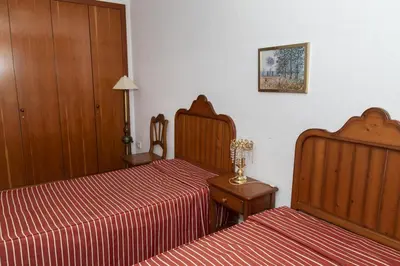 a bedroom with two beds and a table with a lamp at Florazar 2, Viii-8-B in Cullera