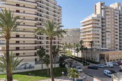 a view of a large apartment building with palm trees at Florazar 3, 3-C in Cullera