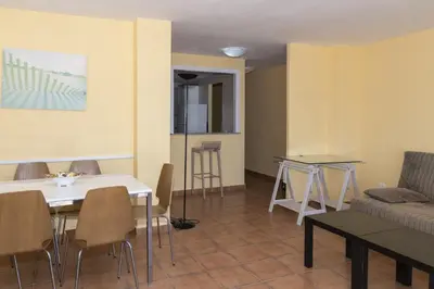 a living room with a couch and a table and chairs at Frontalmar, Esc-B, 8º-32 in Cullera