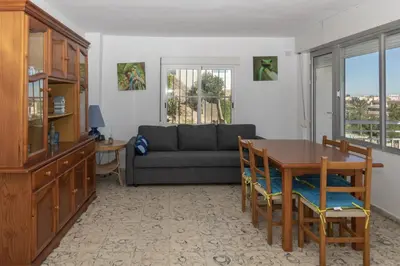 a living room with a couch and a table at Hawai Bajo in Faro de Cullera