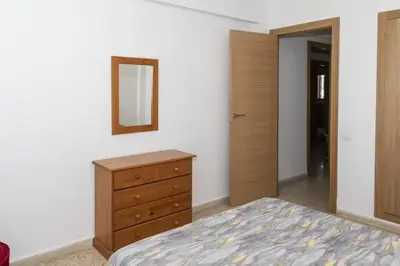 a bedroom with a bed and a dresser and a mirror at Lider, 10-B in Cullera