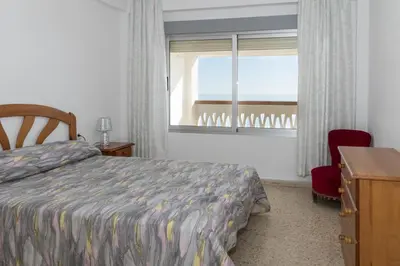 a bedroom with a bed and a window and a desk at Lider, 10-B in Cullera