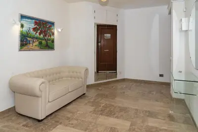 a living room with a couch and a painting on the wall at LIDER, 12º-A Atico in Cullera