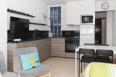 a kitchen with a table and a dining room at Lider, 44-E (Planta Baja) in Cullera