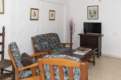a living room with a couch and a table and a tv at Lider, 4-D in Cullera