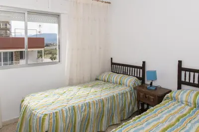 a bedroom with two beds and a window at Lider, 8-A in Cullera