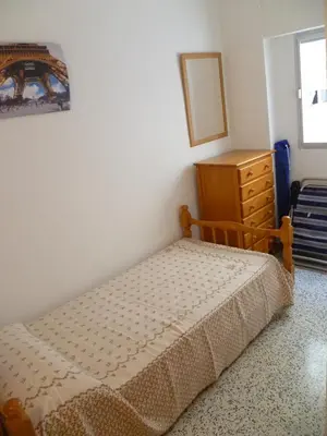a small bedroom with a bed and a dresser at Miralmar, 10º-69 in Cullera