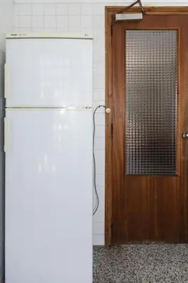 a white refrigerator in a room with a door at Montemar, C-12º-33 in Cullera