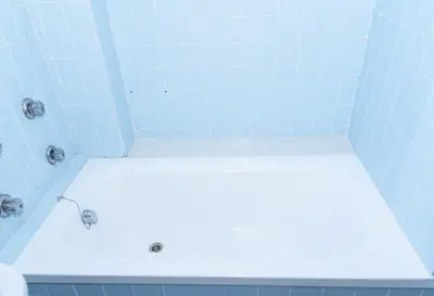 a bathroom with a white tub with blue tiles at Montemar, C-12º-33 in Cullera