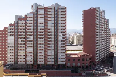 two tall buildings are shown in a city at Montemar, C-12º-33 in Cullera