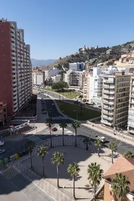 a view of a city with palm trees and buildings at Montemar, C-12º-33 in Cullera