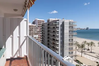 a balcony with a view of the beach and buildings at Montemar, C-8º-22 in Cullera