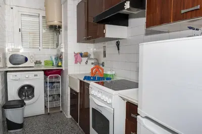 a kitchen with a sink and a washing machine at Montemar, C-8º-22 in Cullera