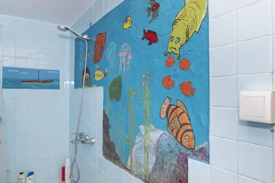 a bathroom with a fish mural on the wall at Montemar, C-8º-22 in Cullera