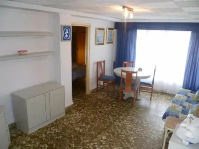a living room with a table and a dining room at Nautic, 7º-O in Cullera