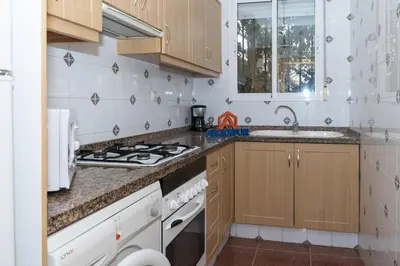a kitchen with a stove and a sink at Pleno Sol, 45 in Cullera