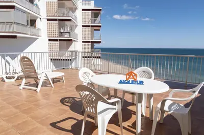 a table and chairs on a balcony with the ocean at Pleno Sol, 45 in Cullera