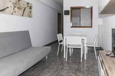 a living room with a table and chairs and a couch at Prado, A-7º-72 in Cullera