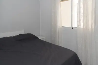 a bedroom with a bed and a window at Saint Germain 7/B1, 8º-16 in Cullera