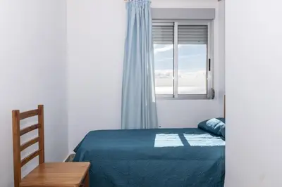a bedroom with a bed and a window at Santa Marta, Iii-A 7º-16 in Cullera
