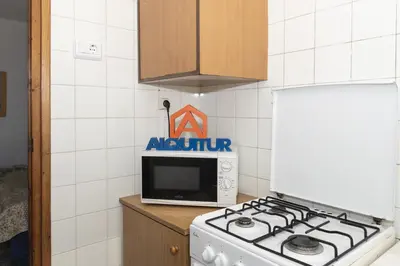 a kitchen with a stove and a microwave at Trianon, 5º-29 in Cullera